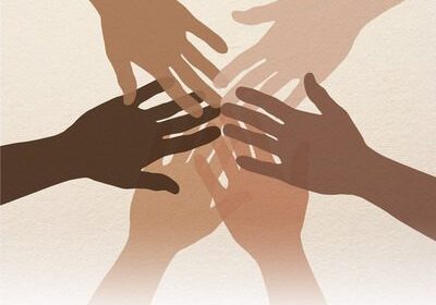 Diverse hands joined in teamwork and unity
