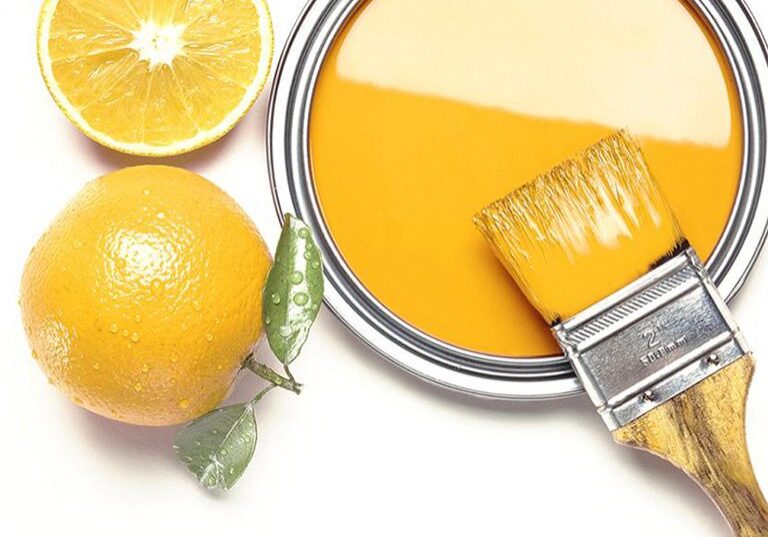Whole and sliced oranges with yellow paint