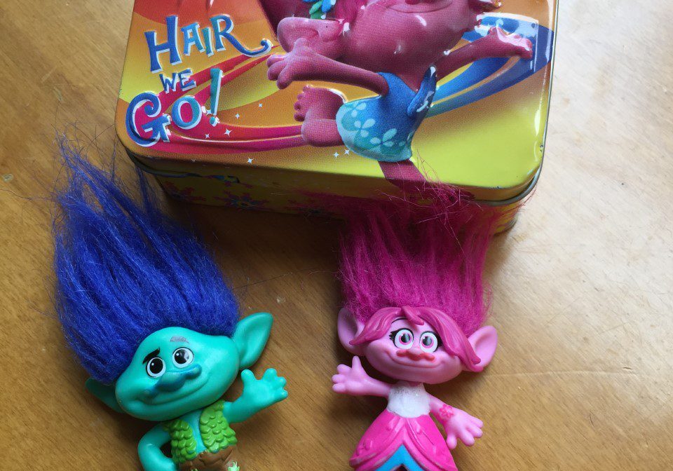 Two Trolls toys with blue and pink hair